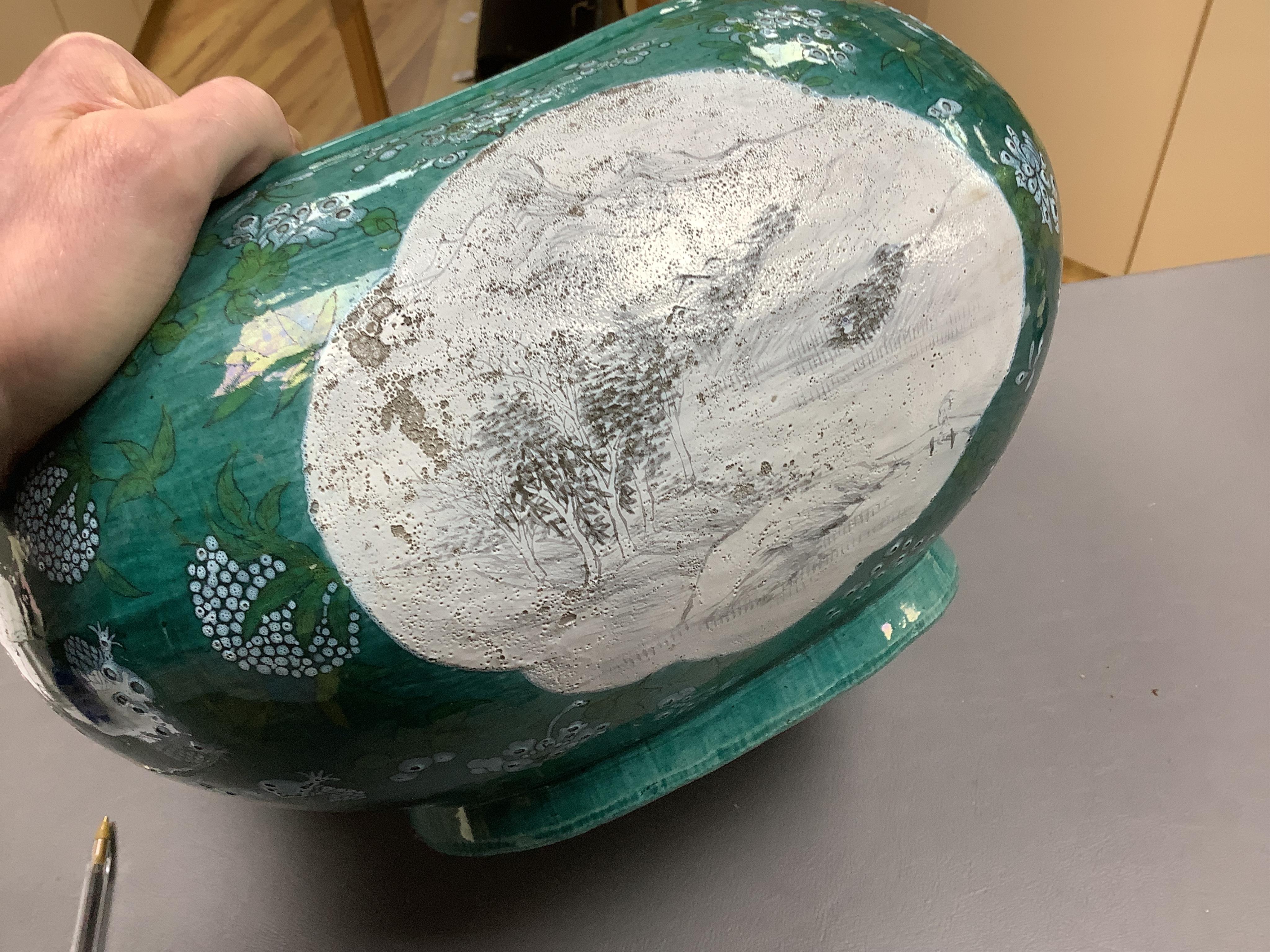 A Chinese enamelled porcelain oval bowl, Guandong kilns, early 20th century, green with en grisaille panels, 20cm high